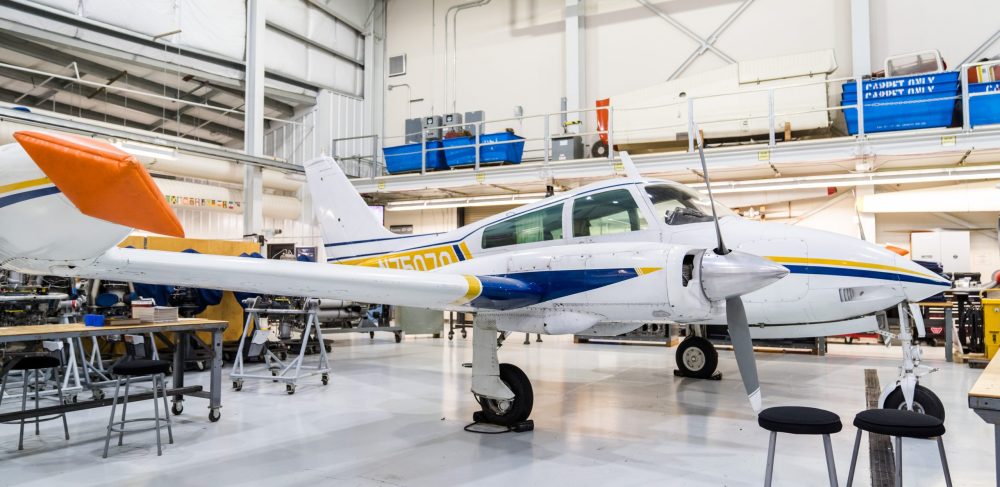 A small airplane parked in the hangar at Rock Creek Campus.