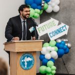 Chris Molinar standing behind podium