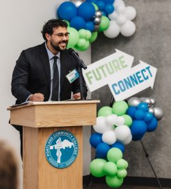 Chris Molinar standing behind podium