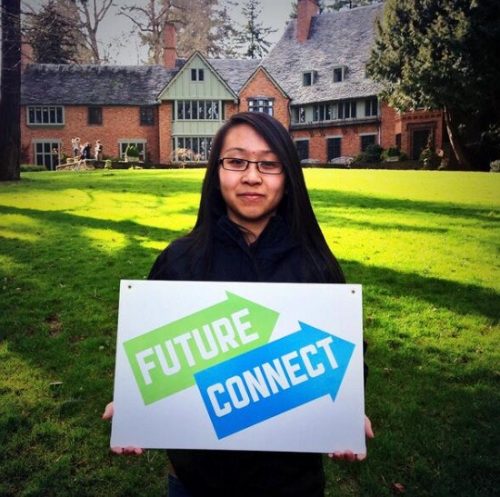 Student holding a Future Connect sign on a university campus