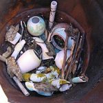 Layers of combustibles, copper carbonate, salt, driftwood and pots are alternated. Pots must be stacked carefully. As the firing progresses, combustibles burn and shifting of the ware occurs.