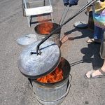 The combustible materials instantly ignite after coming in contact with the hot pot. A lid is placed on the container to smother the flames and create a carbon reduction atmosphere.