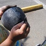 Peel away slip is a type of "naked raku" and is scrapped off of the piece, revealing the white clay body and carbon reduction markings that penetrate cracks of the slip.