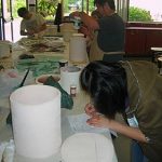 Saggars are closed environments used to locally affect the unglazed surface of the clay. Combustible materials and other elements are added to the saggar before being sealed and fired.