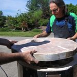 The lid is lifted into place and the "damper" vent lined up in the proper location.