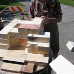 Fire bricks are stacked to make a short chimney to help create oxygen draw over the vent and damper.