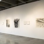 Installation on wall: four large charcoal drawings with 5 small framed drawings