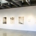 Installation on wall: five large charcoal drawings, with three small framed drawings