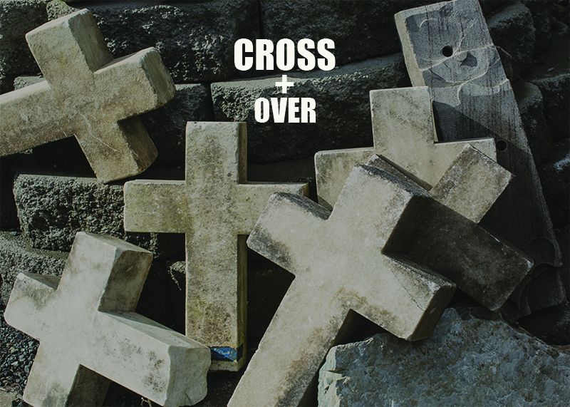 Marble crosses that were former grave markers are loosely piled together.