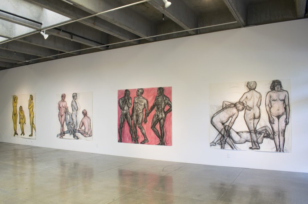 Four large scale drawings, each with three nude figures, drawn in charcoal and watercolor, hung on wall in gallery.