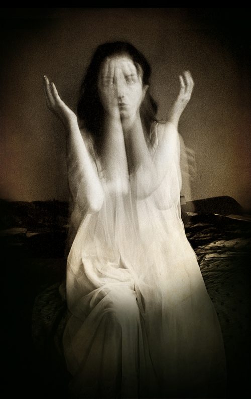 Woman moving her arms in front of her body - out of focus from the movement