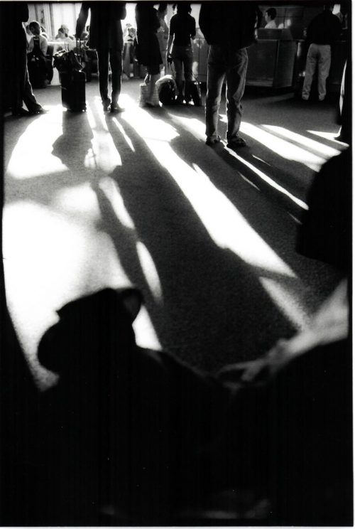 Black and white image of people waiting in LaGuardia Airport