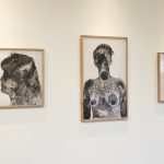 Three framed ink drawings of human figures; the ink is in shades of from black to gray and is in a loose watery style.