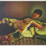 Oil painting of a young man reclining on blankets on a bed. He looks is looking towards the viewer, holding a bottled drink in one hand, while the other hand is reaching into a bag of cookies.