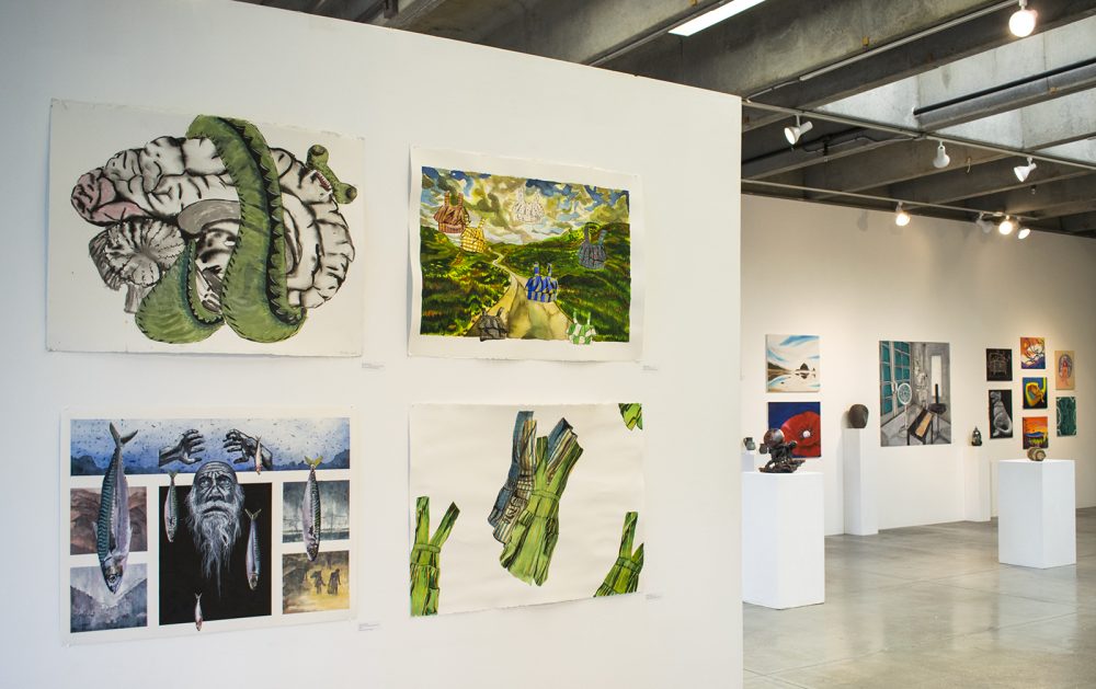 Installation view of a gallery with four multicolored paintings on paper on a wall in the foreground on the left. To the right, in the background are many abstract and representational paintings on the wall and several small ceramic sculptures on pedestals.