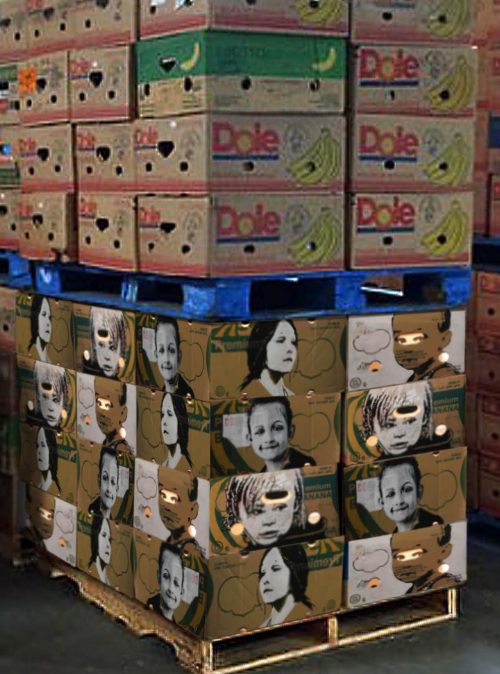 boxes stacked on a pallet - half of them have portraits of people painted on them and half are labeled with Dole Bananas logo.
