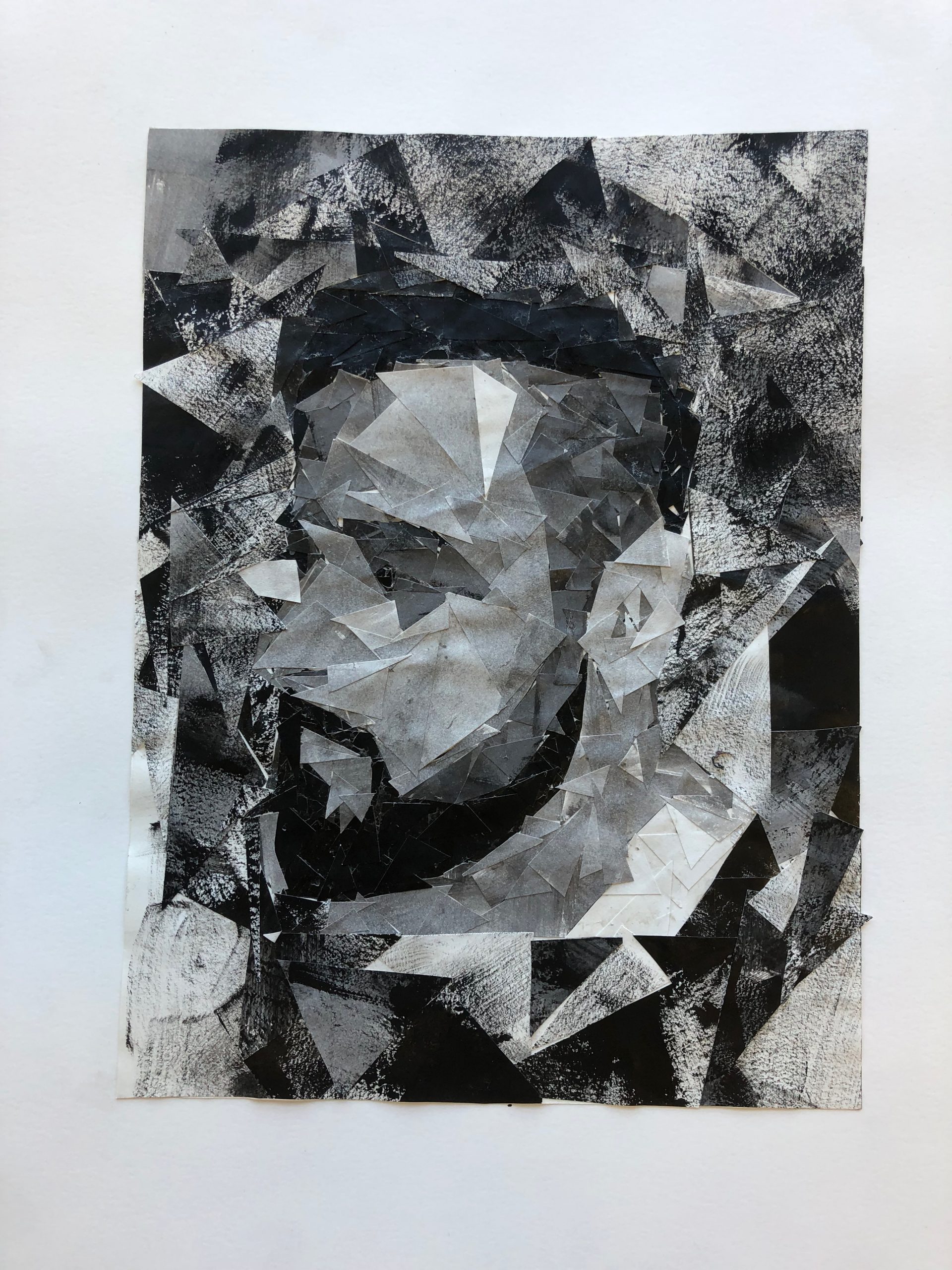 German Amaya, Triangle Self Portrait, 2019, black acrylic paint on cut  triangles of paper, glued to paper medium, 17″ x 14″