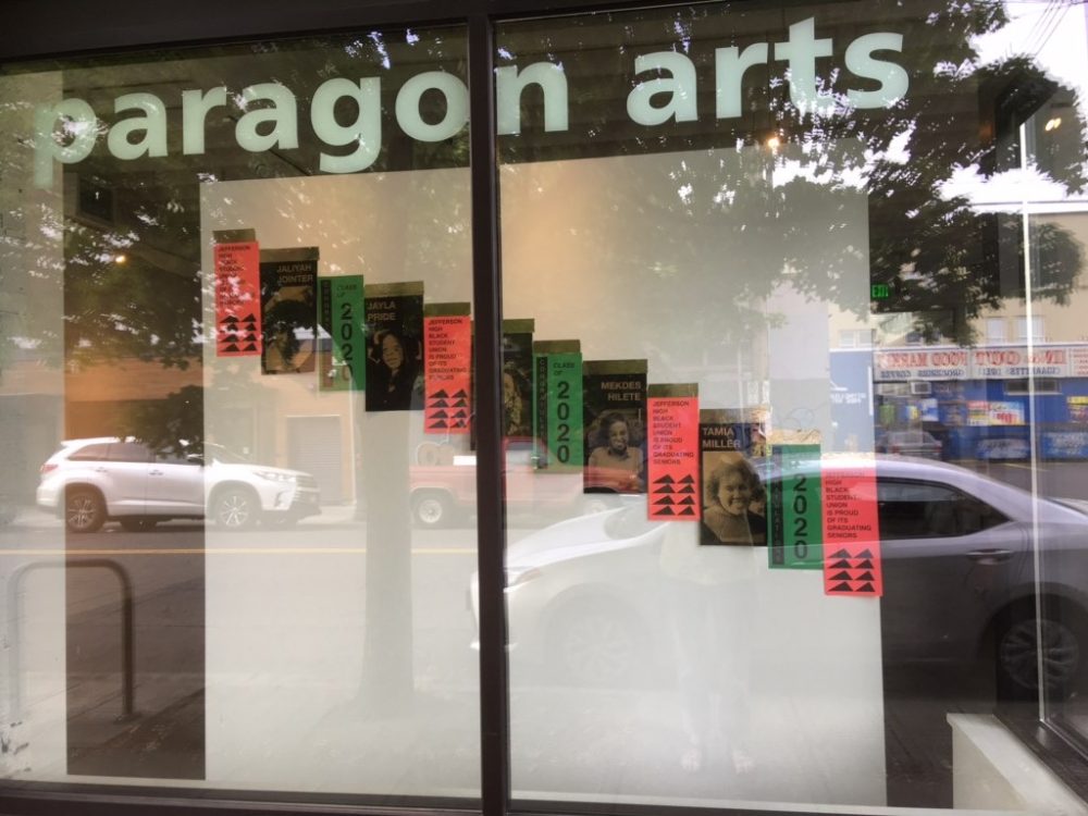 screenprinted posters hanging in the window of the gallery