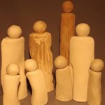 Slab work in clay of 8 forms. All different sizes and shapes with various surface designs grouped together to show connection.