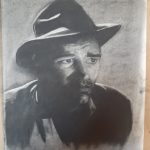 Black and white portrait of a man wearing a 1940's style hat.