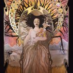 Ophelia is large in the center of the image and is floating in water, wearing a billowing white dress. This image includes art nouveau style framing around Ophelia and the background. In the background is a lake with a large willow tree with a broken branch. The branches of the willow tree are placed so they appear as a continuation of Ophelia's hair that is radiating out around her head. Around her torso is also a round art nouveau frame that includes illustrations of all of the flowers that she gave to others. The colors are bright and warm, and there is a sunset in the sky in the background. A small deer is also laying in the grass in the bottom right foreground.