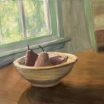 Three red Bartlett pears resting in a ceramic bowl on a wooden countertop, in front of a window, with sun filtering through the leaves of the trees outside.