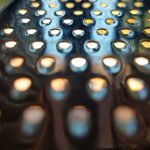 A macro photo of a zester with light coming through the holes.