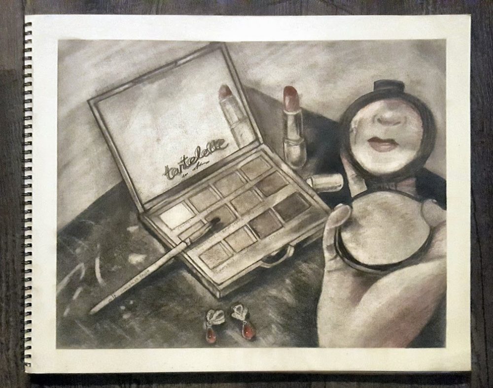 A drawing in graphite with red and brown undertones, a hand of a woman looking at a mirror that is reflecting her lips in a foreground, her eyeshadow kit with a brush, her red earrings in front of it, and an open lipstick behind the kit in a middle ground on a table, and an empty background.