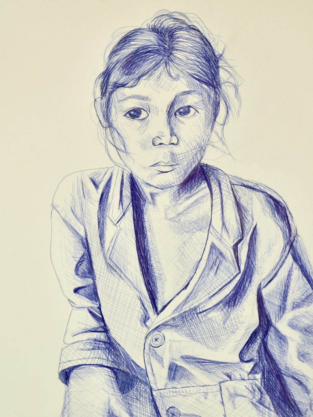 Portrait of a girl in blue ink wearing a coat and with her hair blowing in wind on a white background.