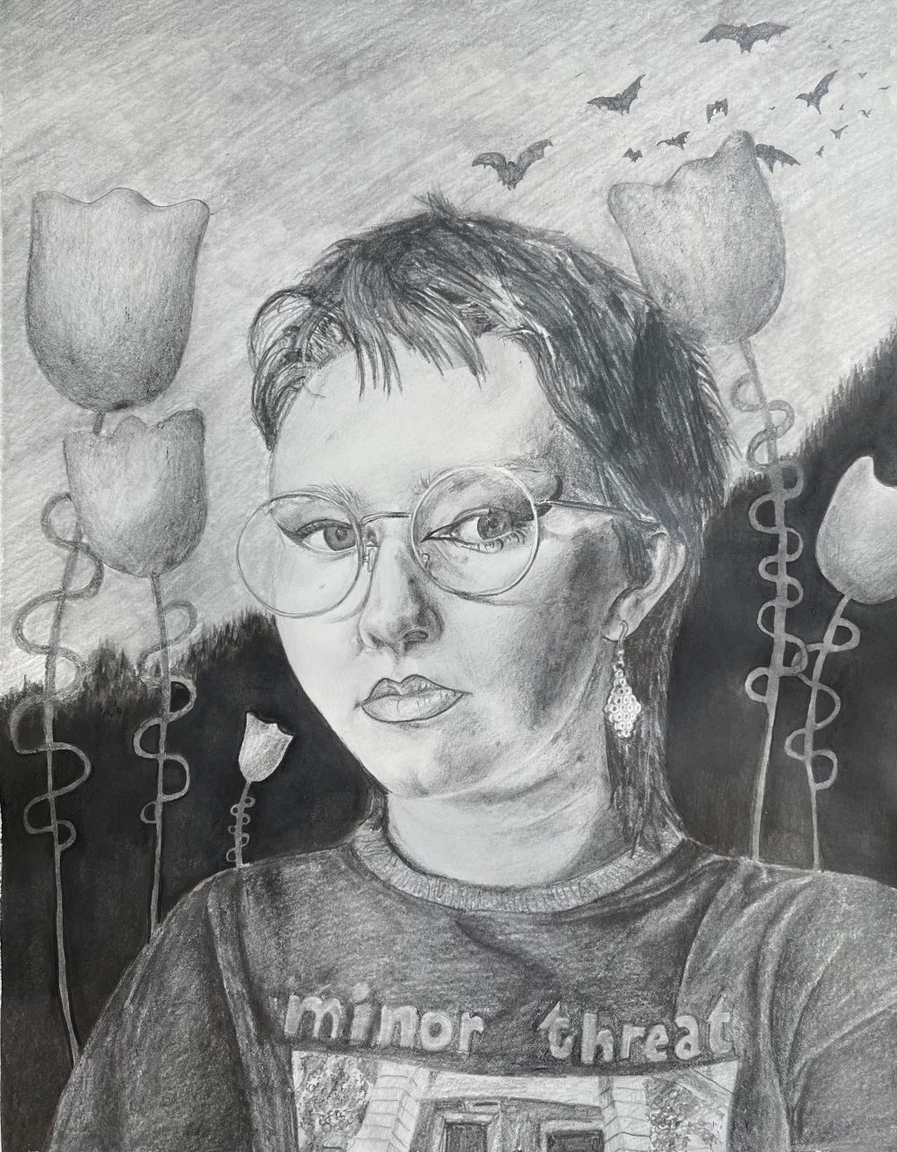 A graphite drawing of a girl with round glasses, a mullet, graphic winged eyeliner and a tee shirt that says "Minor Threat" on it. The background has pine trees in the distance, tall cartoon-like flowers in the middle ground and bats flying through the sky.