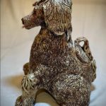 An enormous hand built cookie jar, resembling the posture and personality of our beloved pandemic puppy.