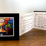 A calligraphy accordion book with a church image on the front.