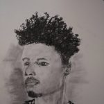 A black and white charcoal drawing depicting a younger black man.