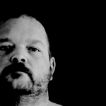 A video performance art piece in black and white.