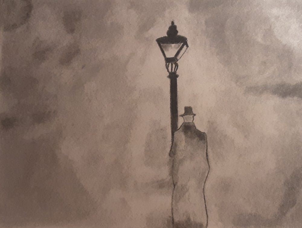 Lone man in a dark, foggy night, standing in front of a light post.