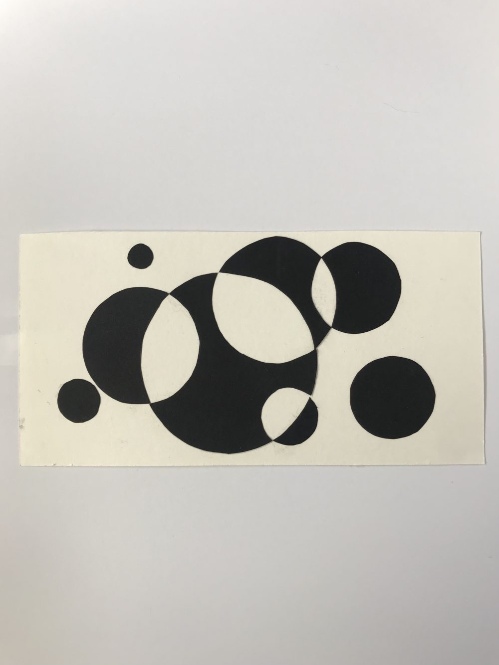 Black overlapping circles on white background.