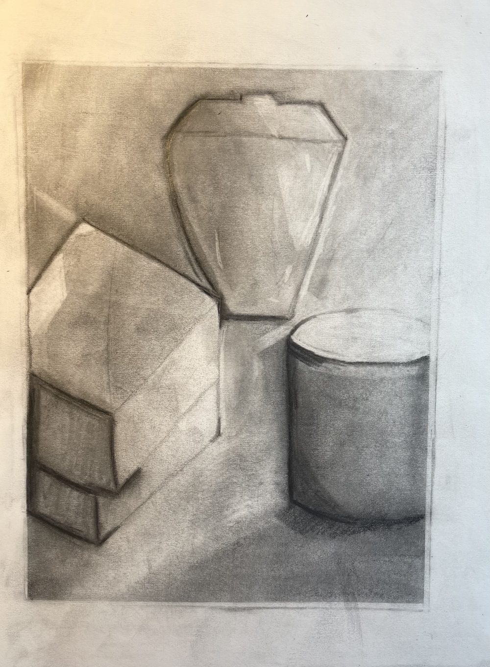 A drawing with between values of black and white of four objects including a cup, two boxes and a pot. The boxes and pot are in the foreground, while the cup is in the background.
