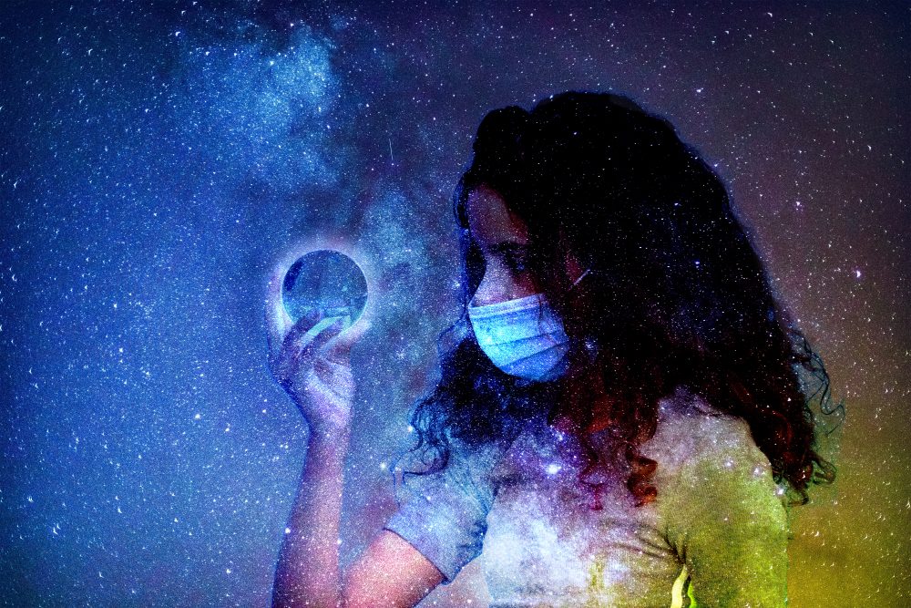 Young girl holding an orb in the midst of the galaxy.