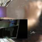 A video still of a hand mirror layered with two other video images of lights and darks and an arm and hand pointing