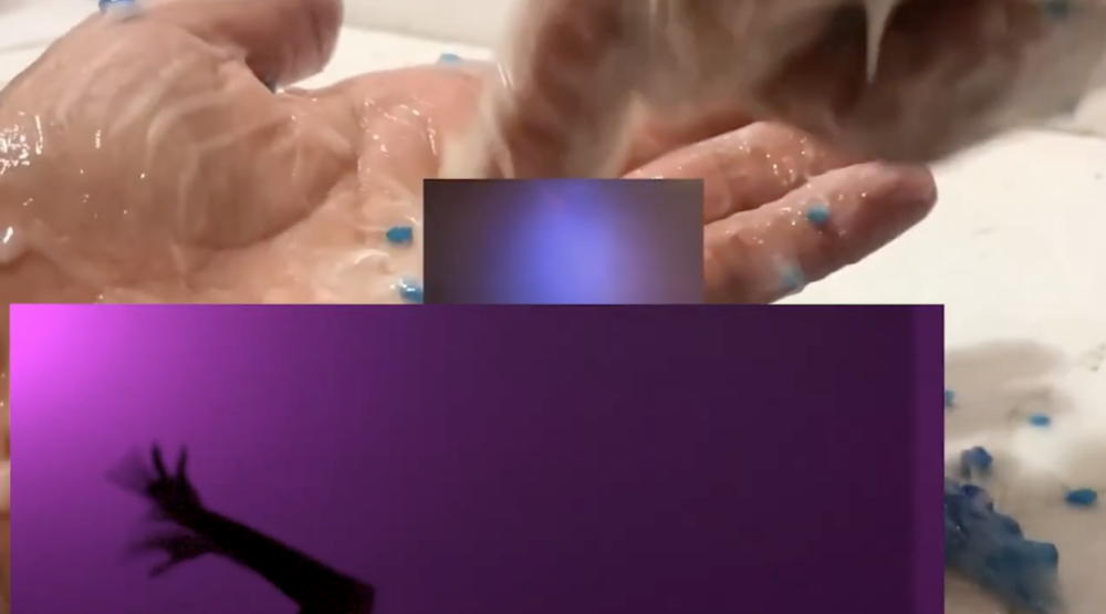 A video still of the palm of a hand layered with two other screens of purple lights and shadows of arms.