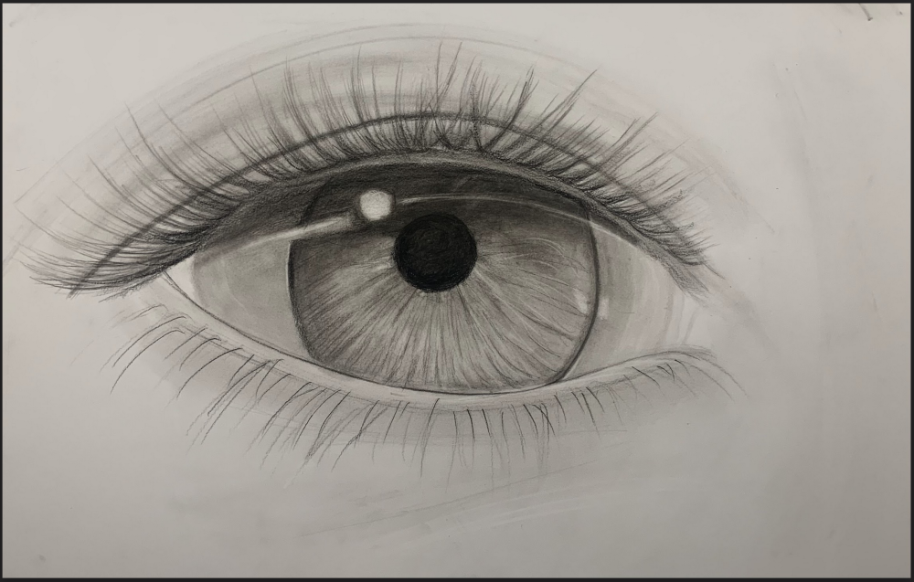 A drawing of a young woman's eye in black and white.