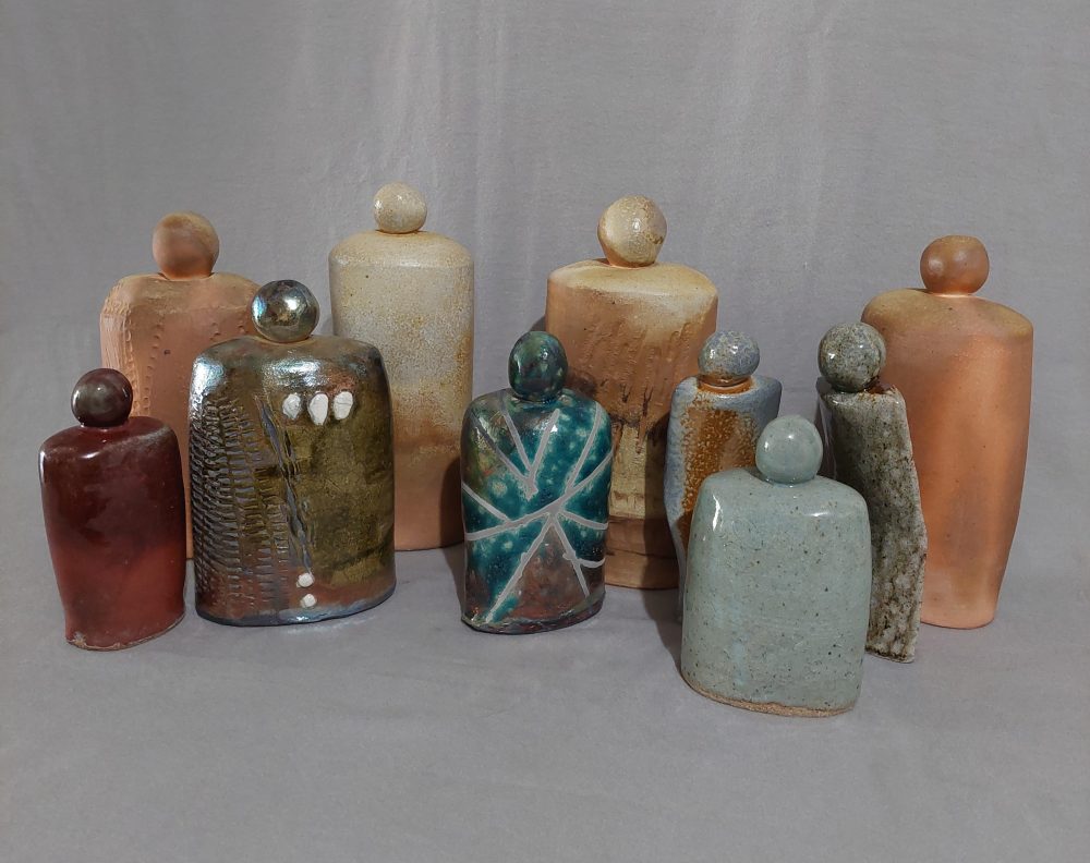 Ten individual pieces showing non-binary, faceless people with no appendages with raku, cone 10 reduction and woodfire surface finish.