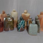 Ten individual pieces showing non-binary, faceless people with no appendages with raku, cone 10 reduction and woodfire surface finish.