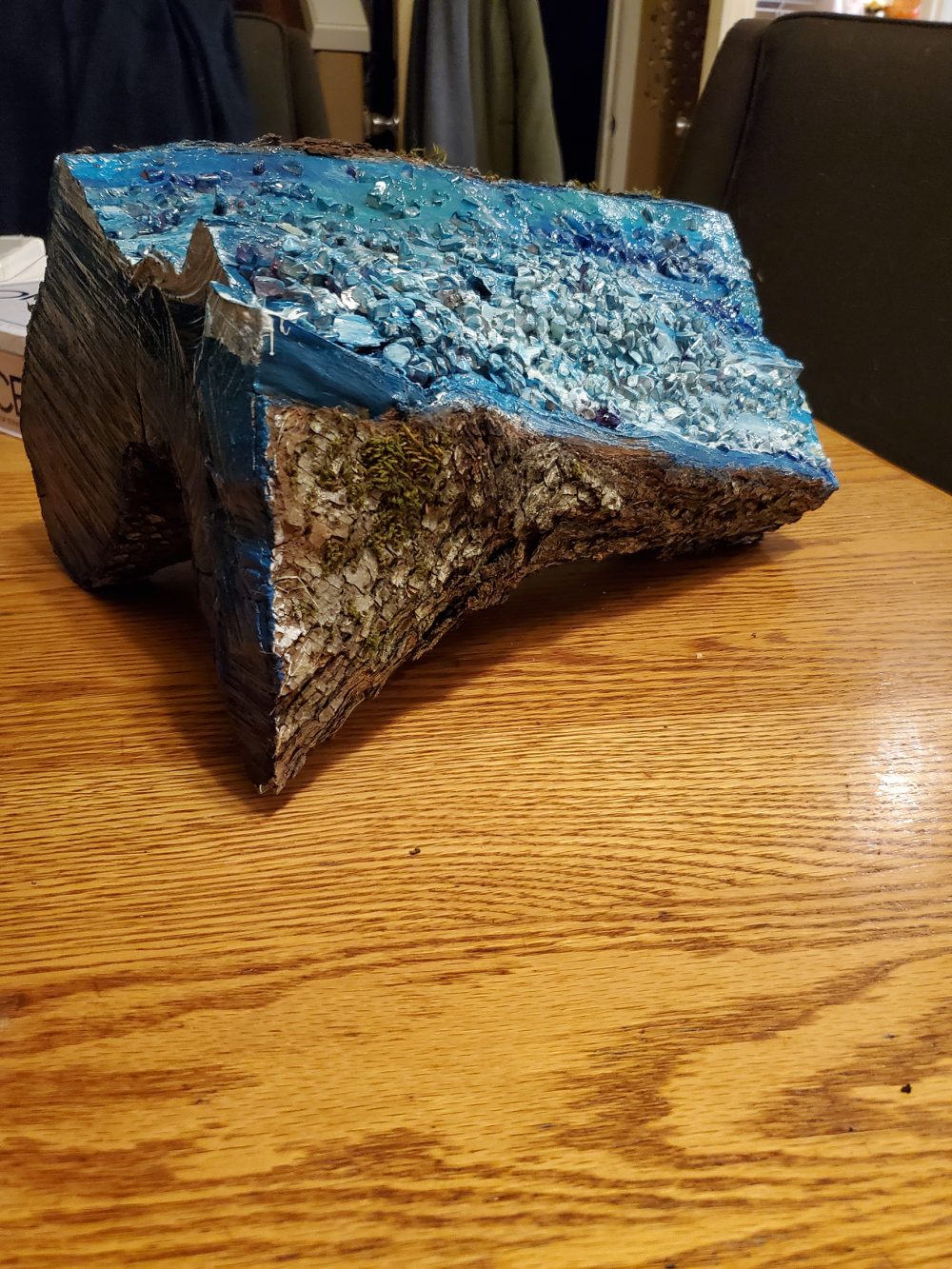 Sculpture of a log formed to look like water.