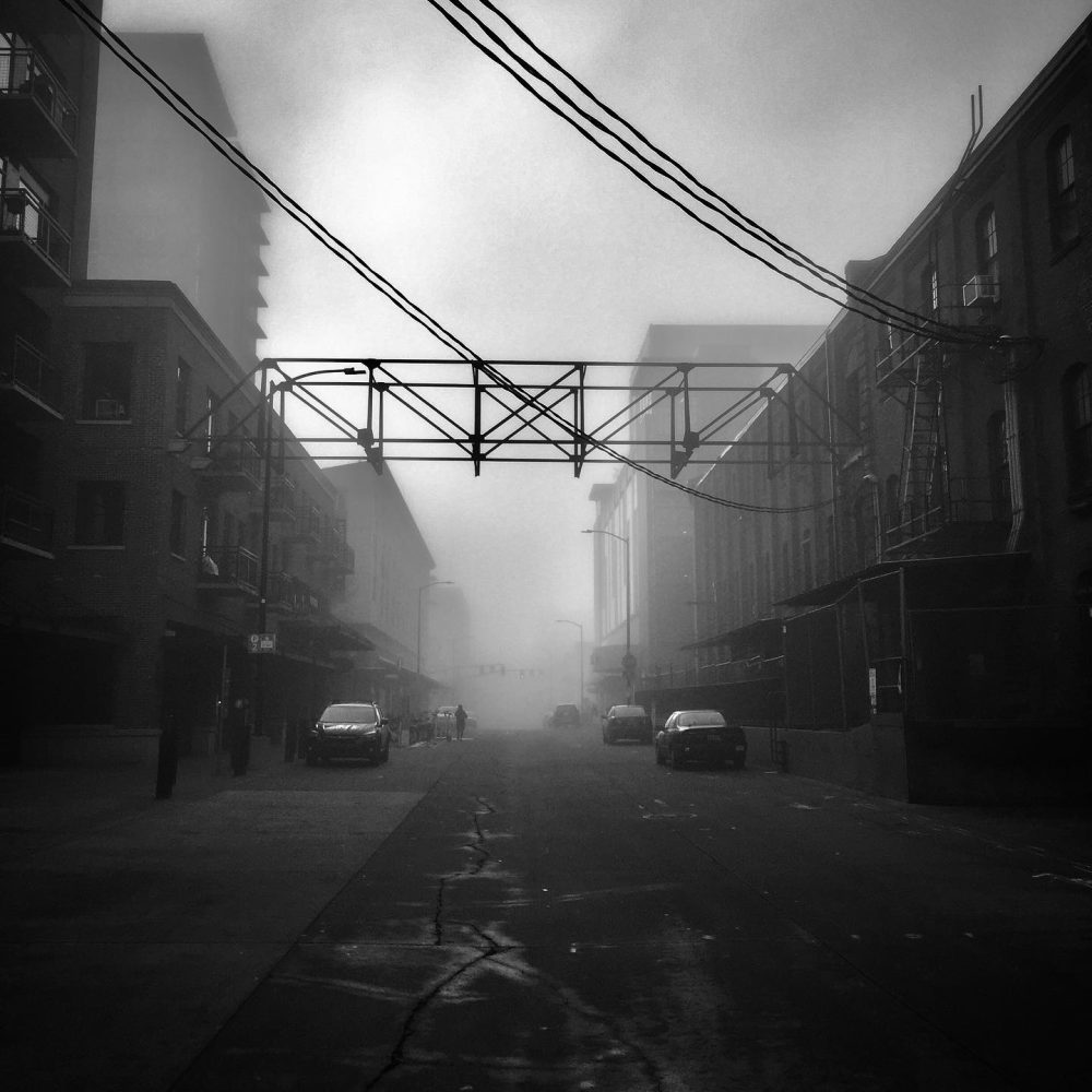 Truss connects town buildings in the misty morning in Pearl District, Portland.