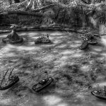 Black and white photograph of six miniature remote controlled boats scattered within a miniature water scene with a couple of isles and mountains in the background.