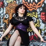 Portrait of an alternative teenager with graffiti art in the background.