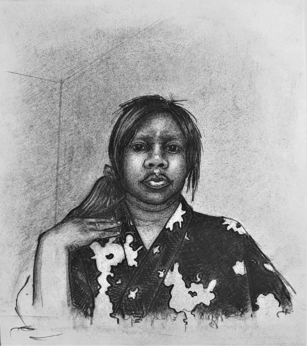 Portrait of a young female model with her hand on her shoulder, wearing a floral robe.