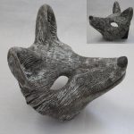 A brown and white mask that is the shape of a fox's face.