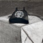 A dark black phone resting on top of a white box with a gray back ground.